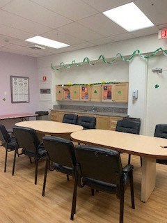 a classroom with tables and chairs in a room