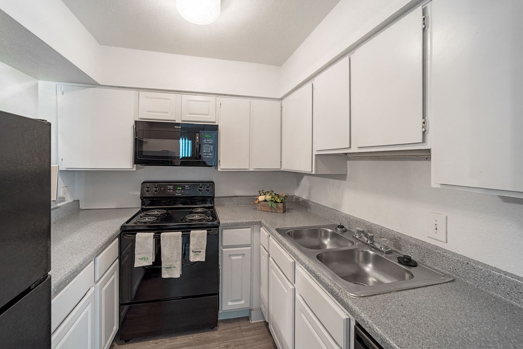 Updated Kitchen With Black Appliances at Carelton Courtyard Apartments, Galveston, 77550