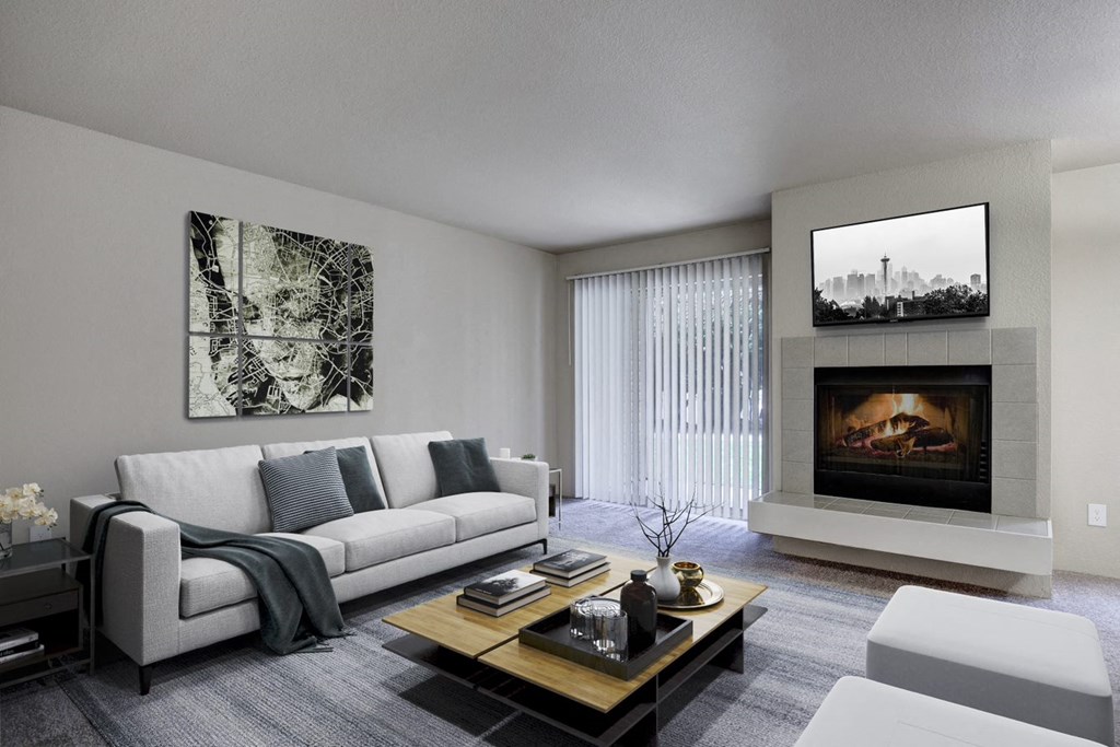 a living room with a couch and a coffee table and a fireplace