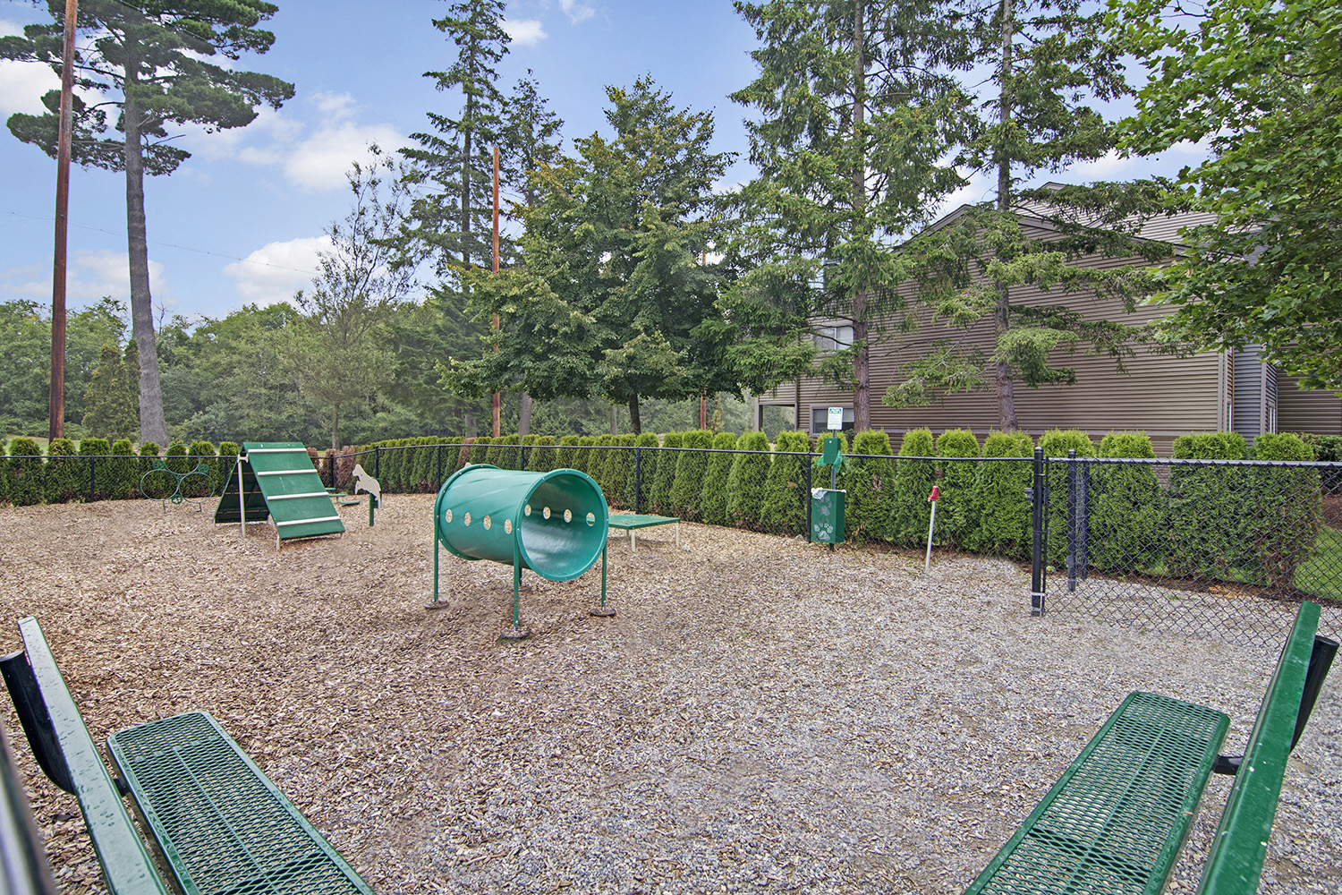 a park with a playground and benches