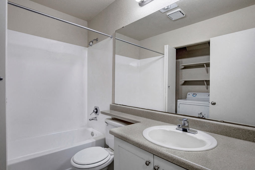 a bathroom with a sink toilet and a mirror