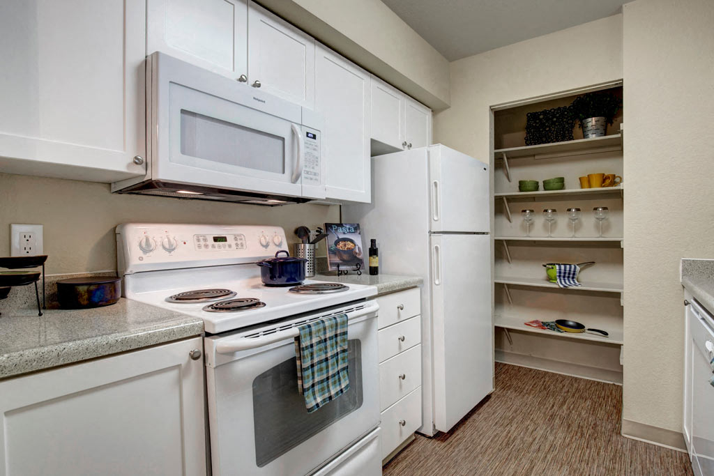 a kitchen with white appliances and a white refrigerator