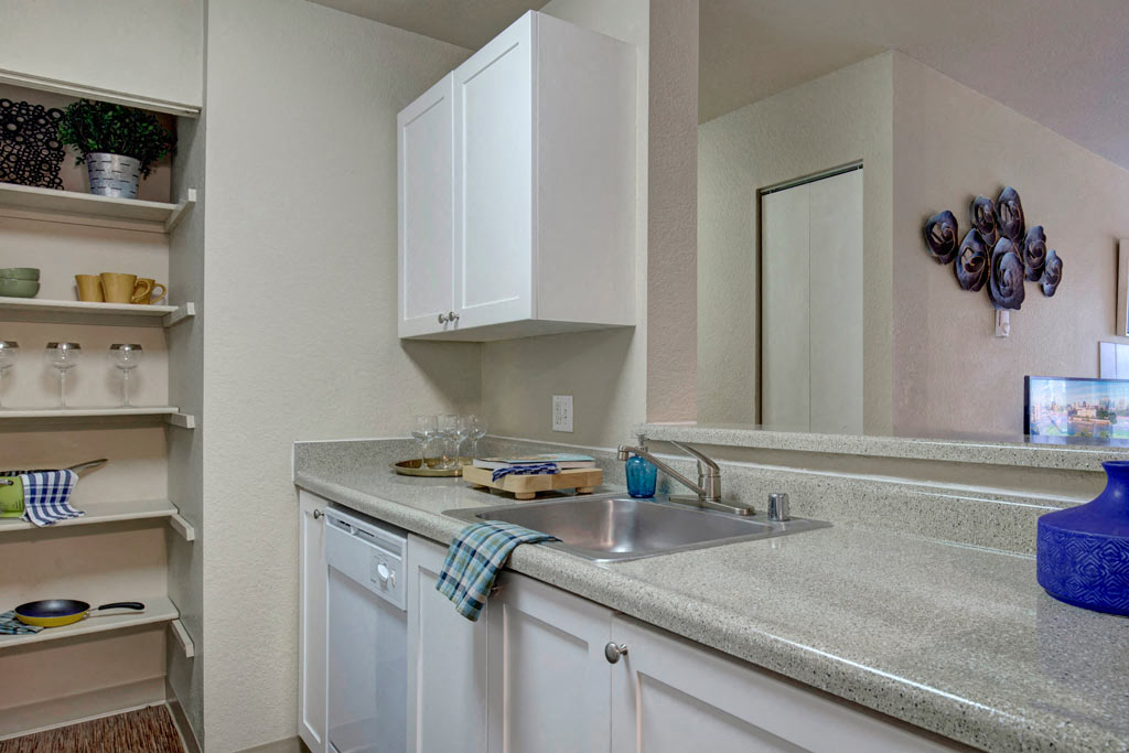 a kitchen with a sink and a mirror