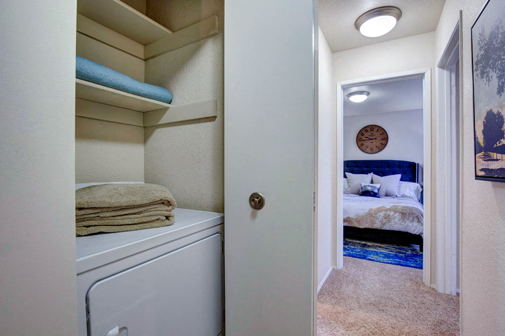 a laundry room with a bed and a closet