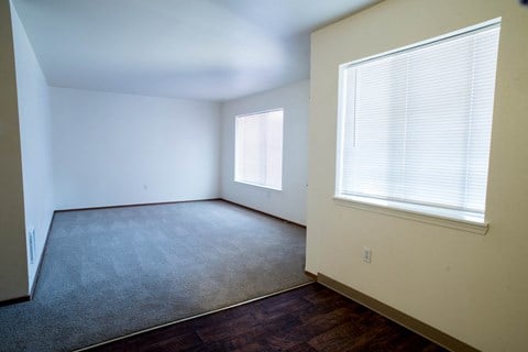 a bedroom with a large window and a carpet