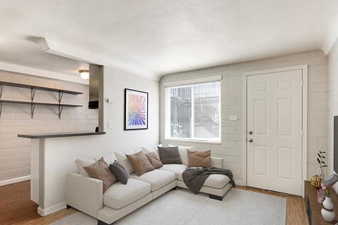 a living room with a white couch and a white door