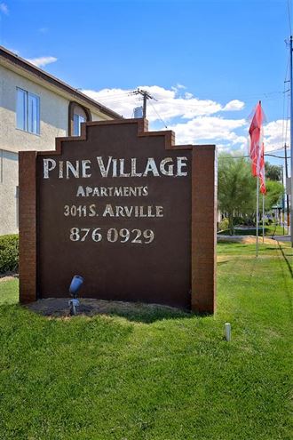 pine village apartments sign 