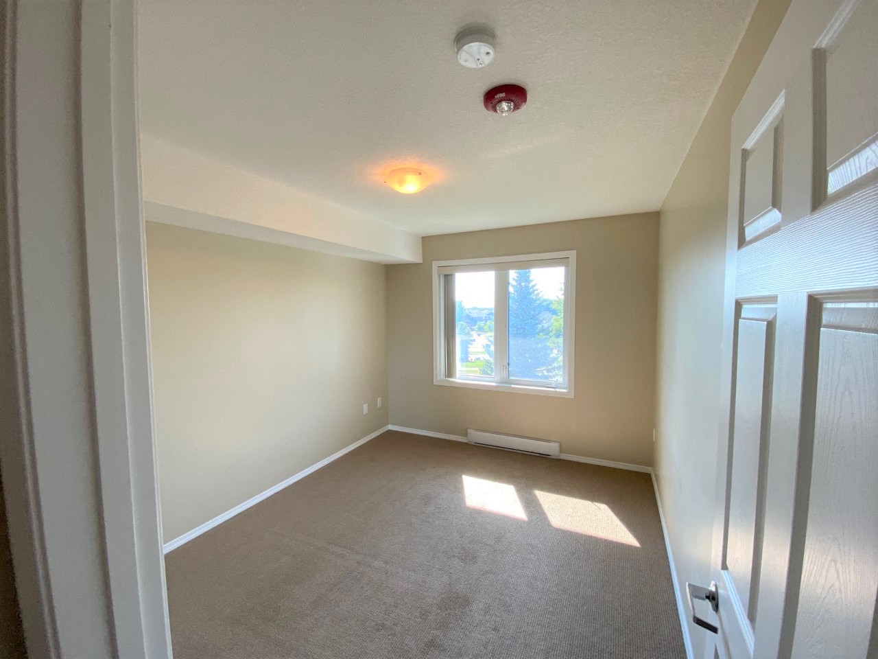 a empty room with a window and a door