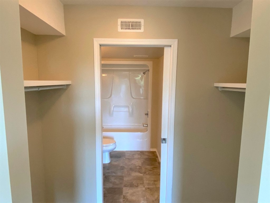 a small bathroom with a toilet and a closet