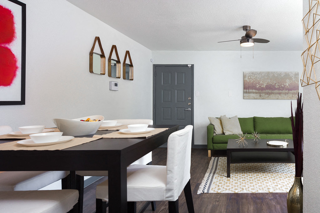 a dining room and living room with a table and chairs