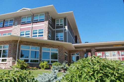 a large brick building with a blue sky in the background