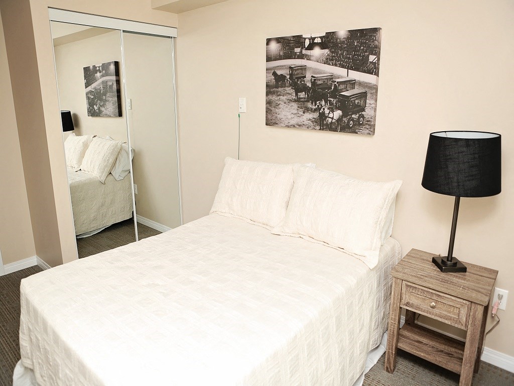 a bedroom with a bed and a mirror