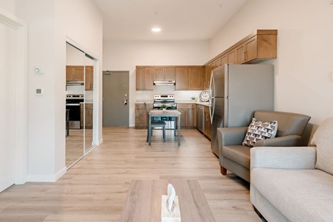 A modern kitchen with a dining table and a couch.