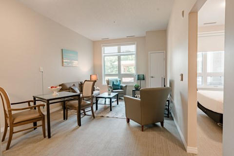 A living room with a table and chairs.
