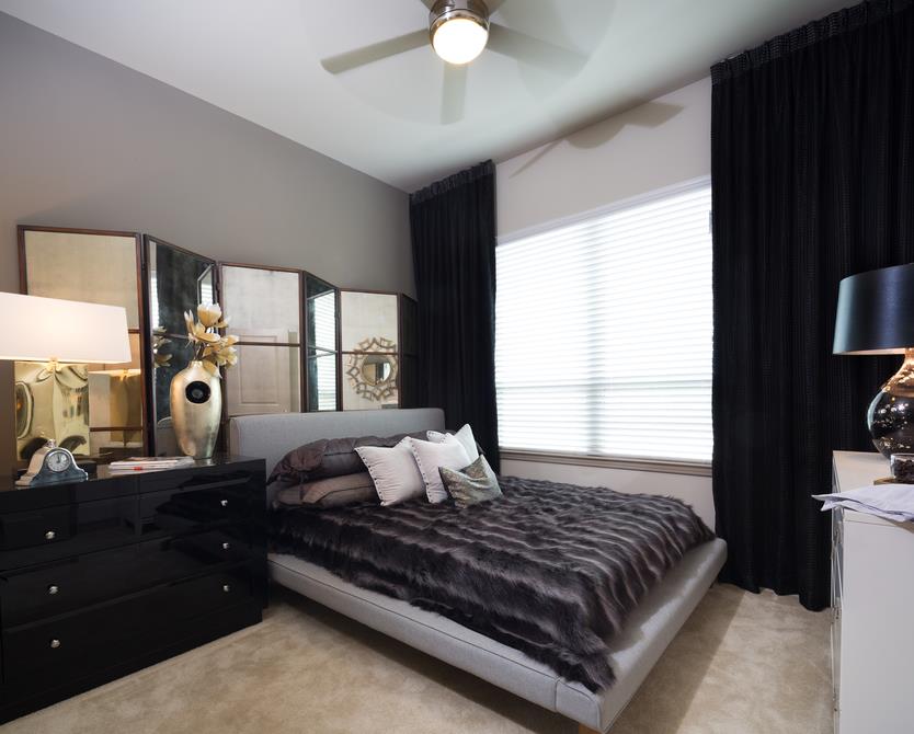 bedroom with large window and ceiling fan
