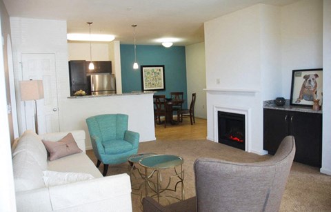 a living room with a couch and a chair and a fireplace
