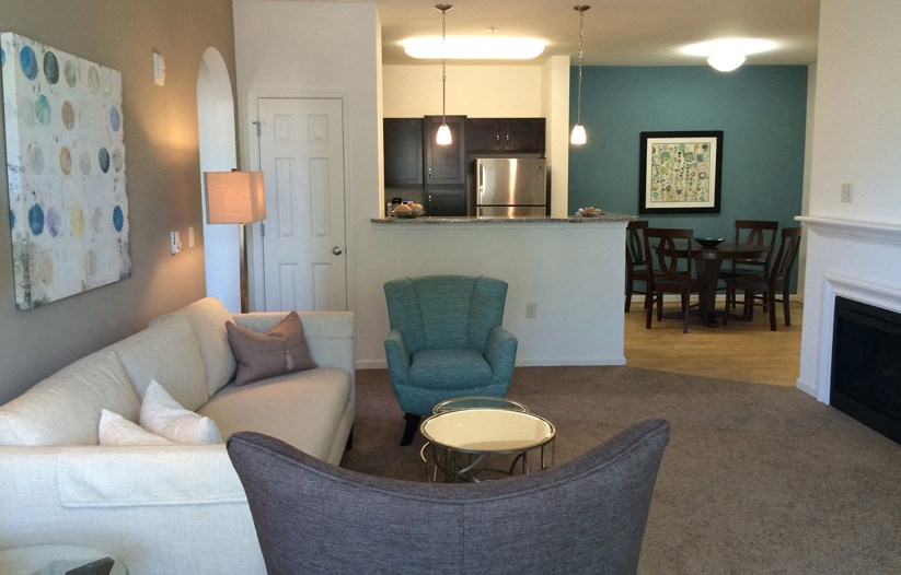 a living room with a couch and a chair and a table