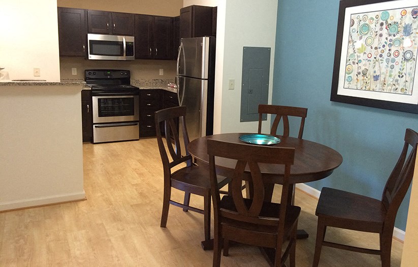 a kitchen and dining room with a table and chairs