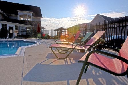 a group of beach chairs sitting next to a pool