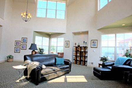 a living room with leather furniture and large windows