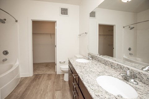 A white bathroom with a tub, toilet, and sink.