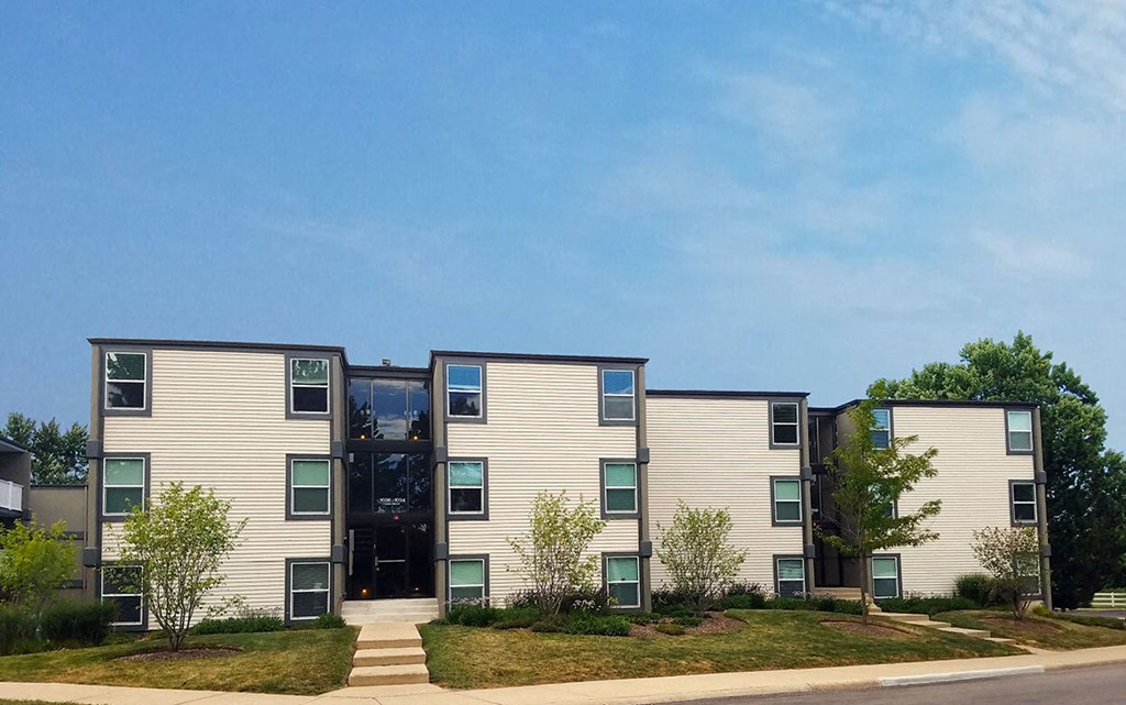 a row of houses with trees in front of them