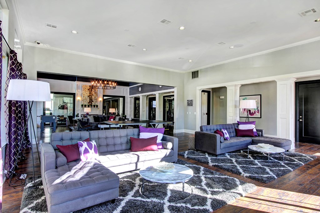 a large living room with couches and a rug