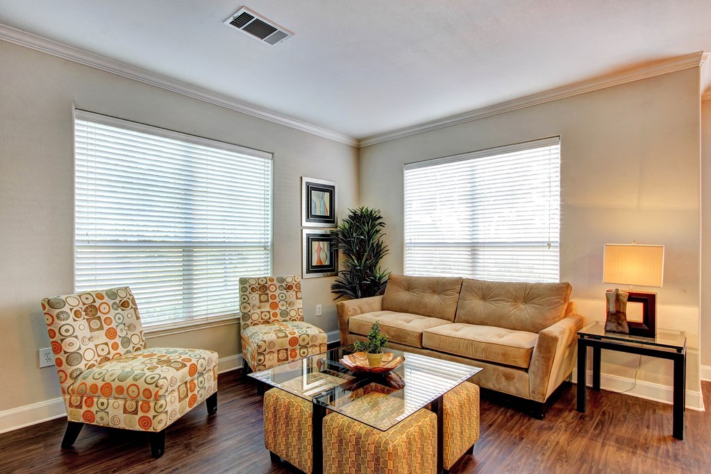 a living room with a couch and two chairs