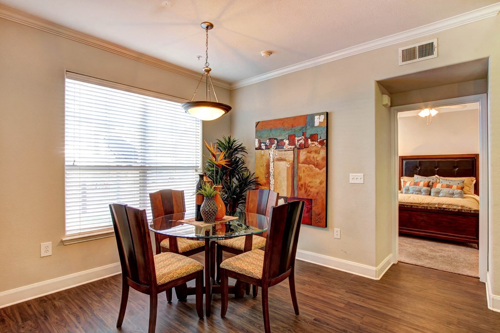 a dining room with a table and chairs and a large window