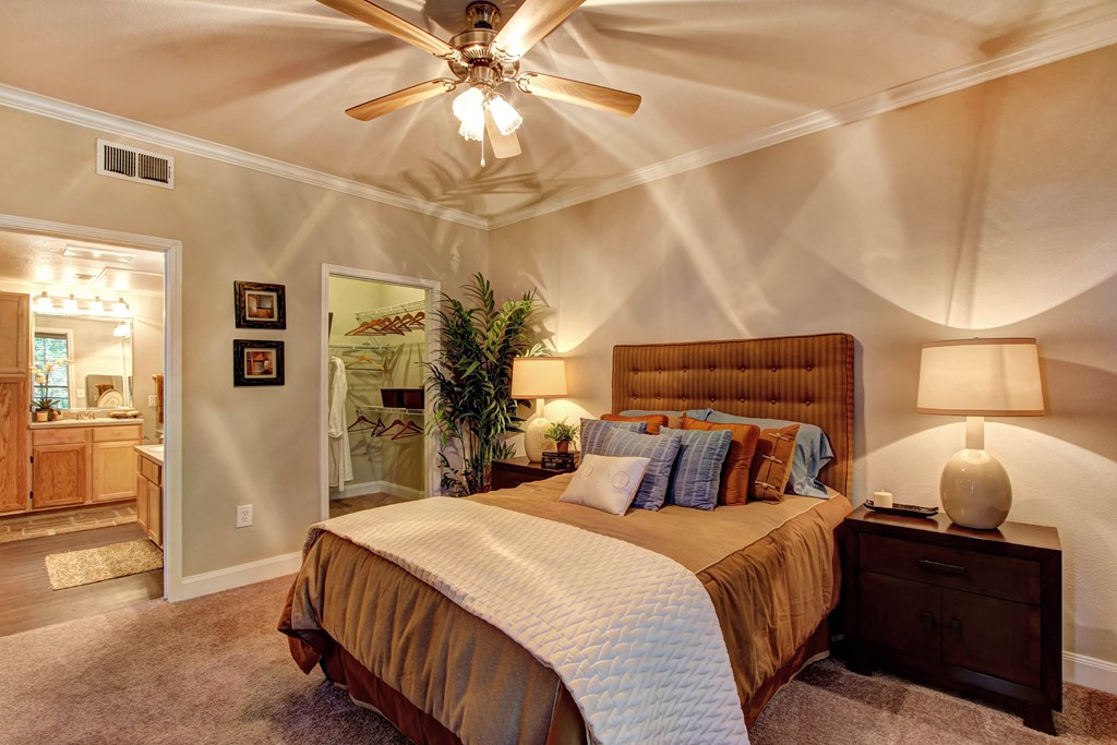 a bedroom with a bed and a ceiling fan