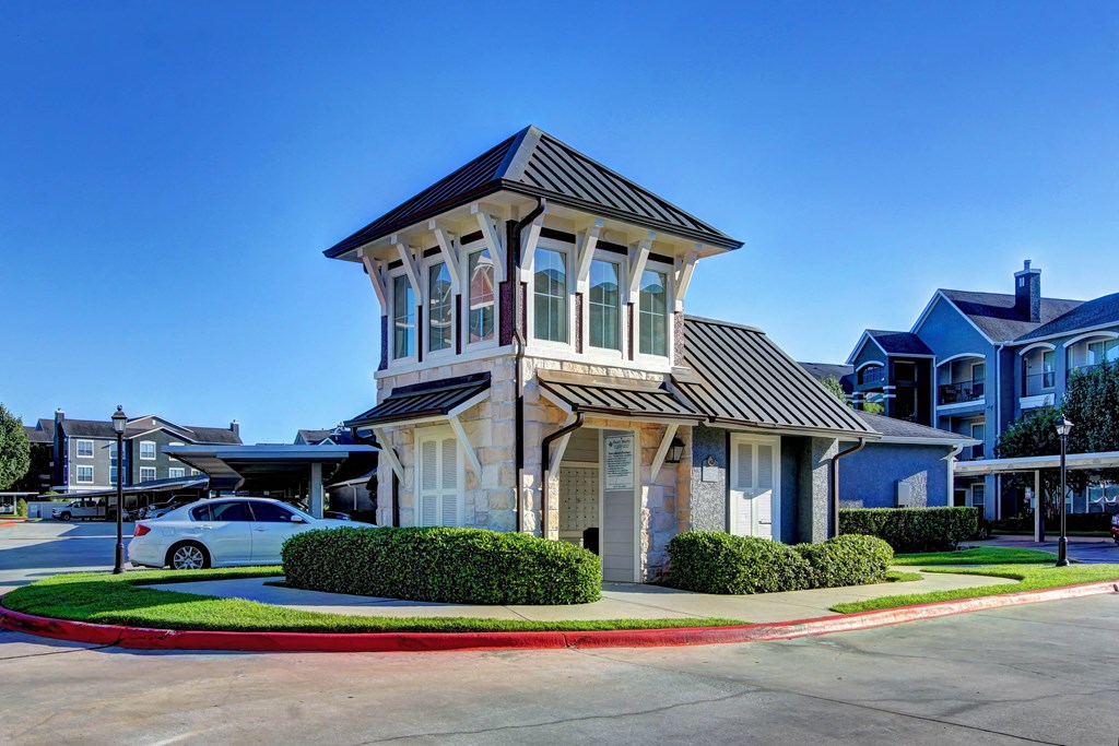 a house with a tower on top of it on a street