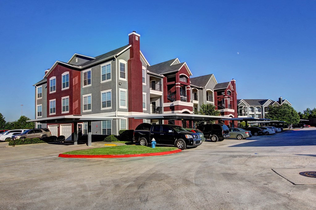 a parking lot in front of a apartment building