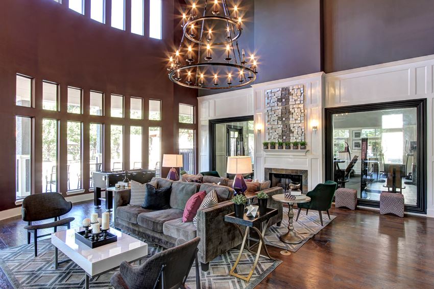 a living room with a large chandelier and a fireplace