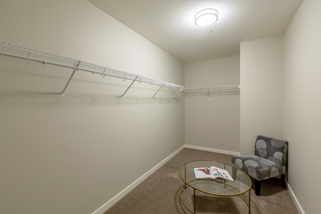 a room with a closet and a chair and a table