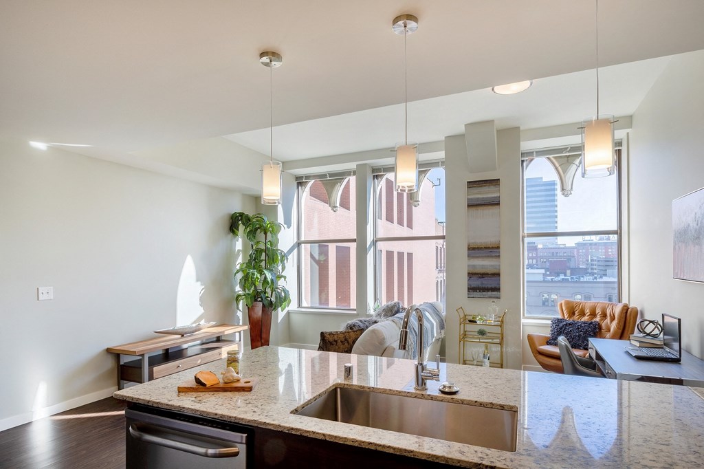 an open kitchen and living room with a large window