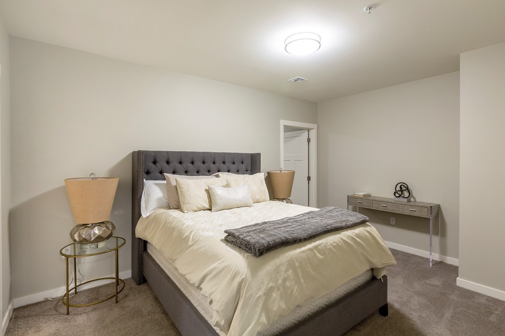 a bedroom with a bed and two night stands and a closet