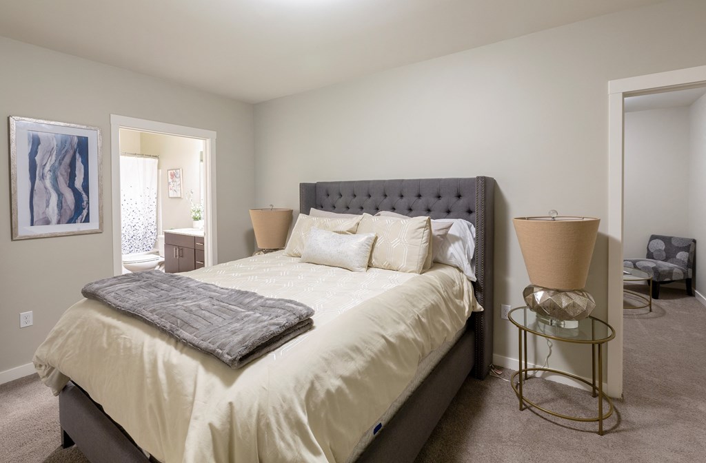 a bedroom with a large bed and a bathroom