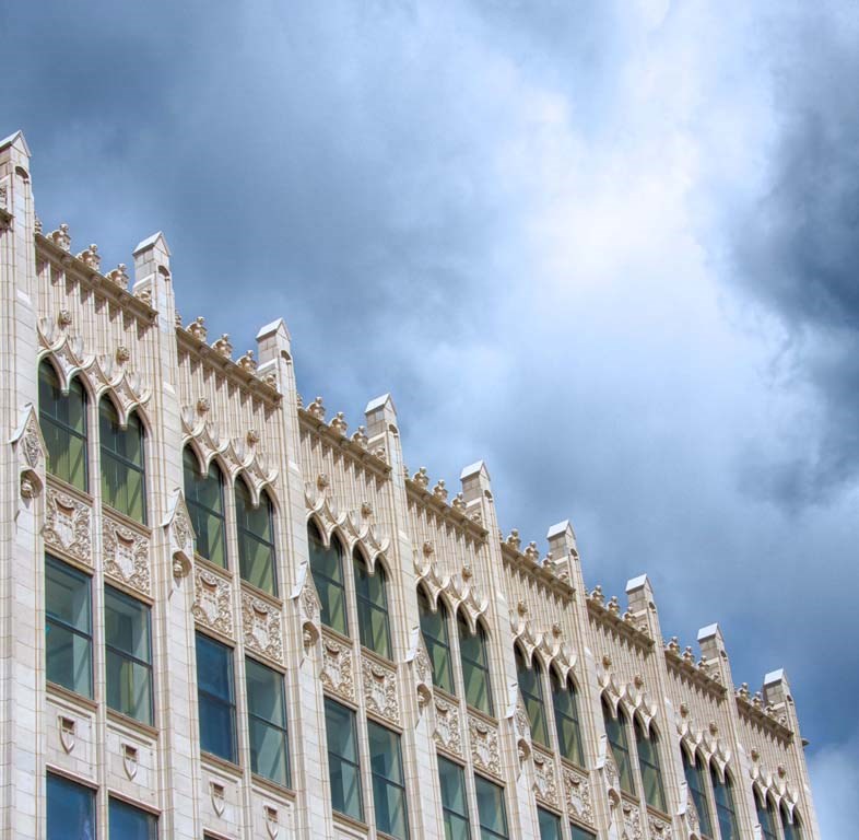 the side of a building with a cloudy sky