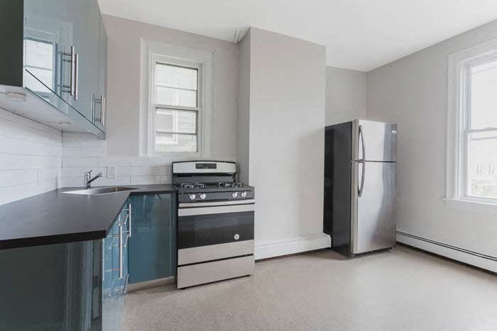 a kitchen with a stove and a refrigerator