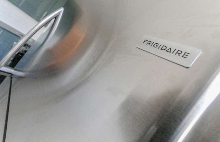 a sign on the side of a stainless steel stove