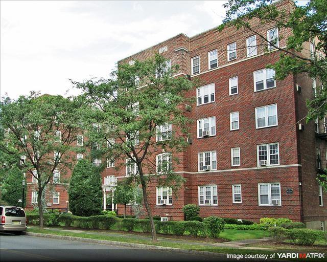 A brick building with trees in front of it.