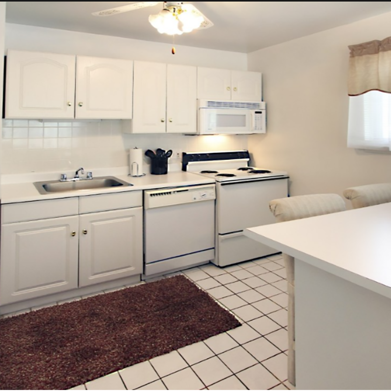 a white kitchen with white appliances and white cabinets