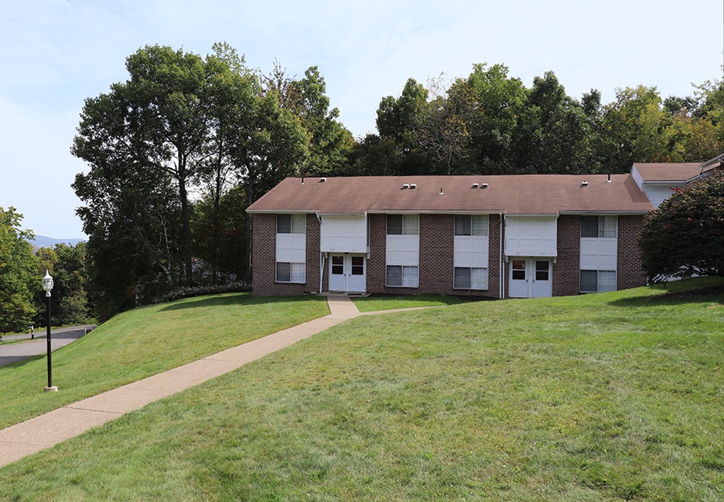 a building on the side of a hill with a sidewalk