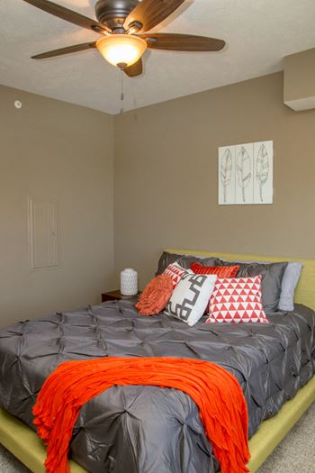 Bedroom with queen sized bed and ceiling fan at The Villas of Omaha at Butler Ridge in Omaha, NE