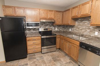 Large kitchen with many cabinets for storage and stainless steel appliances