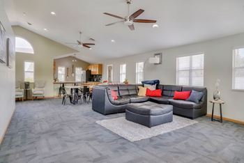 Common area with lounge area and kitchen in the clubhouse at Skyline View apartments