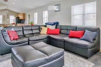 Sectional sofa and matching ottoman in the clubhouse at Skyline View apartments
