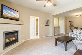 Spacious carpeted living room with fireplace at Ridge Pointe Villas in South Lincoln, Nebraska