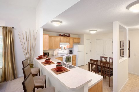 a view of a kitchen and dining room with a table and chairs