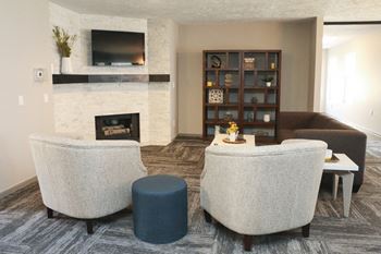 Sitting area near fireplace and TV in community clubhouse at Eagle Run